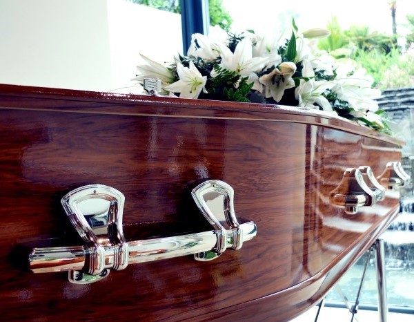 Coffin, funeral cars and flowers